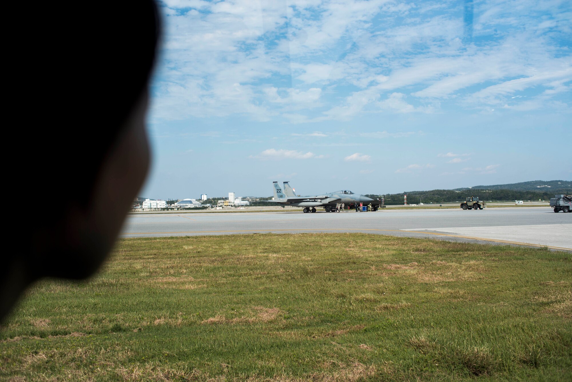 A member of the Japanese Air Self Defense Force watches as the 18th Logistics Readiness Squadron fuels management flight hot pit refuels a U.S. Air Force F-15 Eagle on Kadena Air Base, Japan, Nov. 21, 2013. Hot pit refueling is a capability where fighter jets are refueled with the engine still on, which allows them to take-off shortly after landing. (U.S. Air Force photo by Airman 1st Class Tyler Prince)