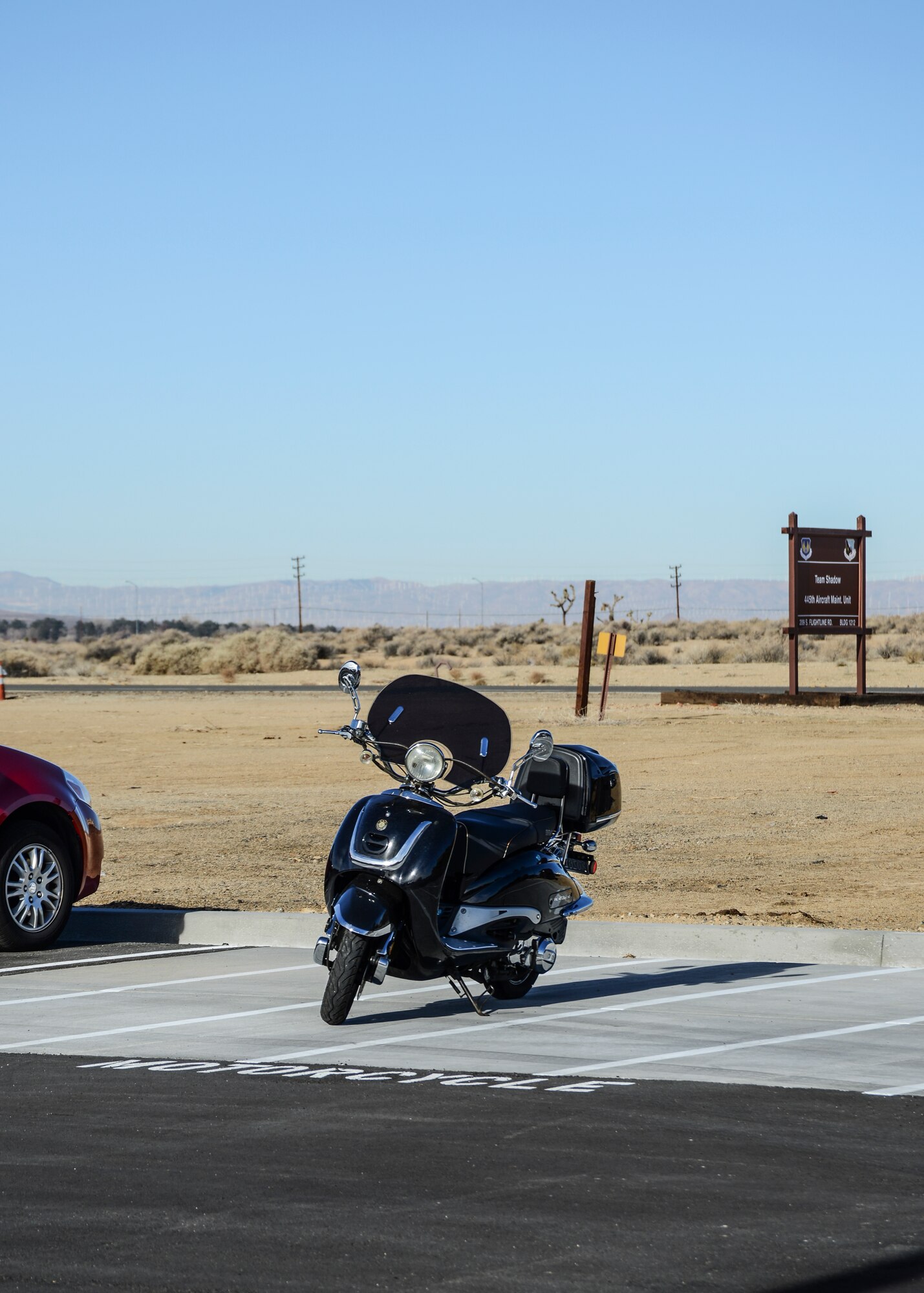 The designated motorcycle parking area is made of concrete, which is not as easily damaged by kickstands. (U.S. Air Force Photo by Rebecca Amber)