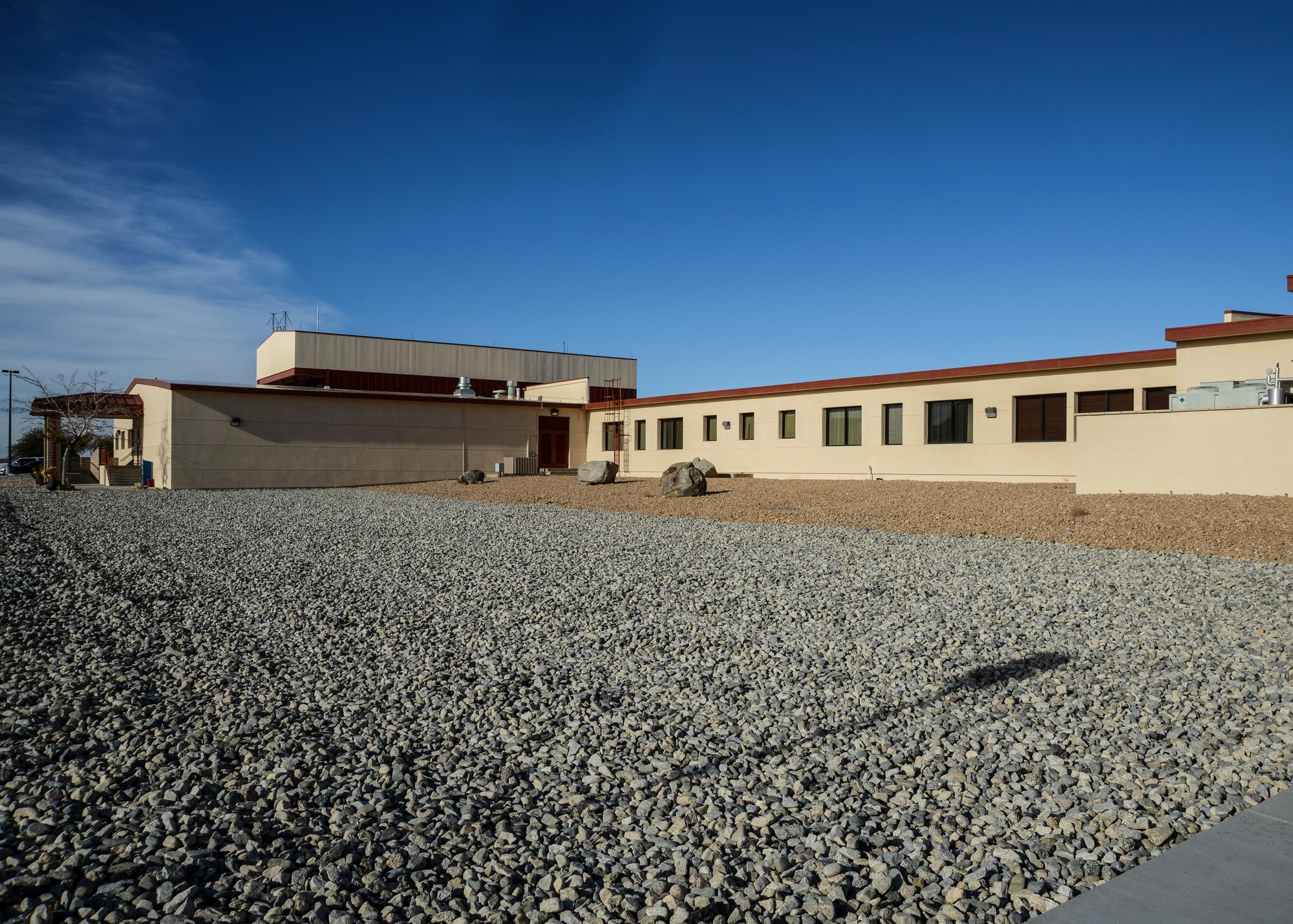 The area behind the United States Air Force Test Pilot School was filled with rock landscaping to comply with anti-terrorism standards. The gray rock distinguishes the new rock area from the older, red rock area. (U.S. Air Force Photo by Rebecca Amber)