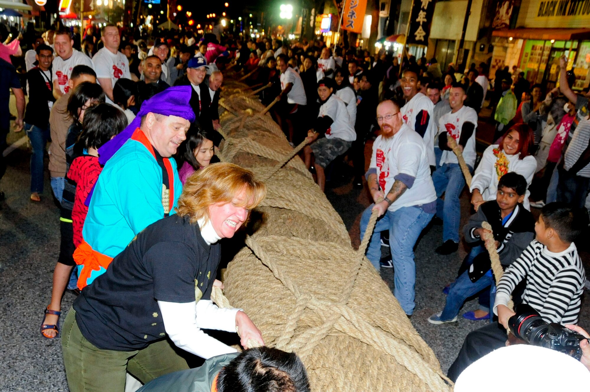Participants pull the rope to win the tug-of-war competition at the end of the International Carnival in Okinawa City, Japan, Nov. 30, 2013. Approximately 22,000 people attended the 22nd International Carnival outside of Kadena's Gate 2.  (U.S. Air Force photo by Staff Sgt. Darnell T. Cannady)