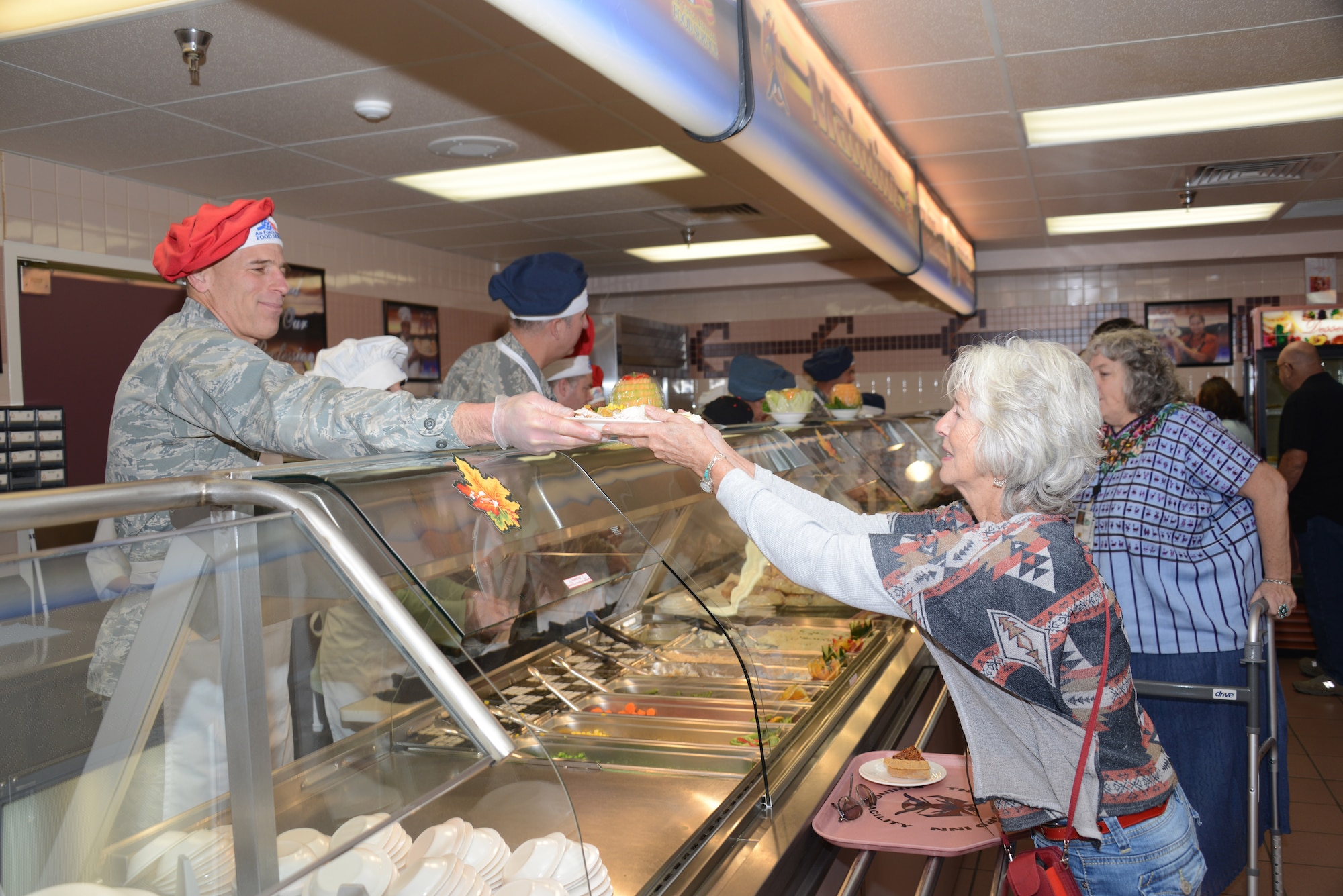 Col. David Goldstein, Phillips Research Site and Materiel Wing commander and Space Vehicles Directorate director, serves Thanksgiving dinner at the Kirtland Dining Facility. Senior leaders were at the facility Thanksgiving Day to serve meals to Airmen and retirees. (Photo by Dennis Carlson)