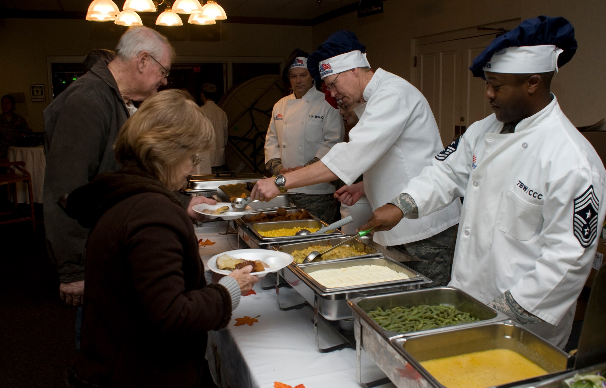 7th Bomb Wing leadership serves a Thanksgiving meal Nov. 28, 2013, at Dyess Air Force Base, Texas. The buffet-style meal, hosted by the 7th Force Support Squadron, was provided from 11 a.m. to 2 p.m., and was open to the entire military community including their families and retirees. Brig. Gen. Glen VanHerck, 7th Bomb Wing commander, along with group commanders, chiefs and other volunteers served food to those who attended. (U.S. Air Force photo by Senior Airman Peter Thompson/Released)