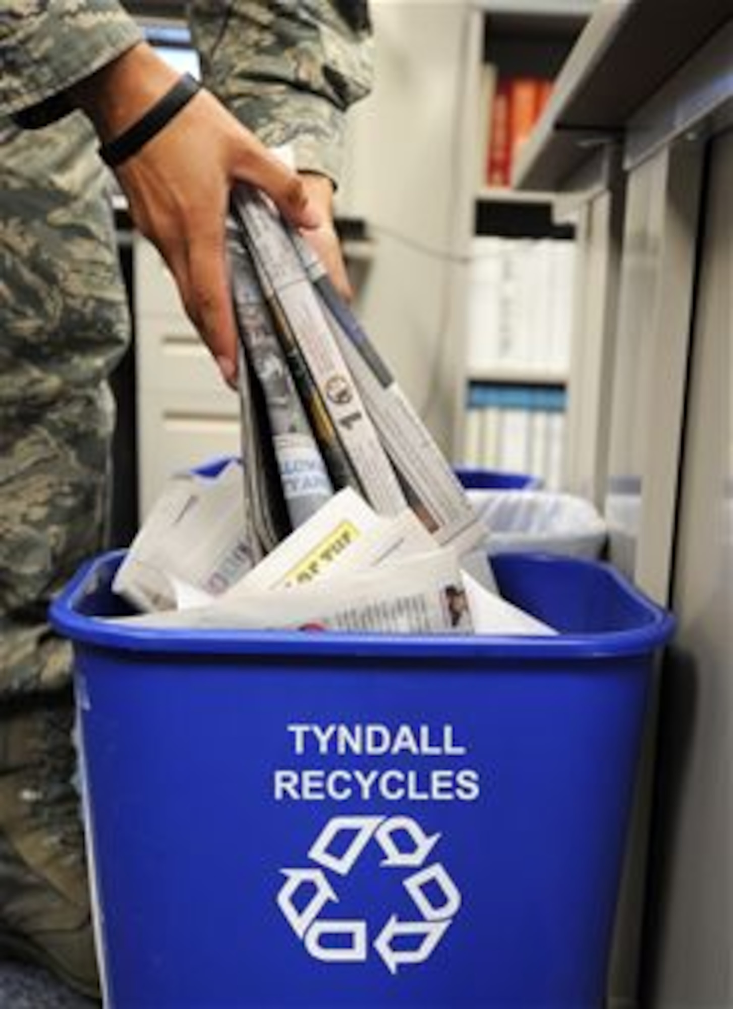 Team Tyndall Airman recycling Dec. 12. (U.S. Air Force photo illustration by Airman 1st Class Alex Echols)