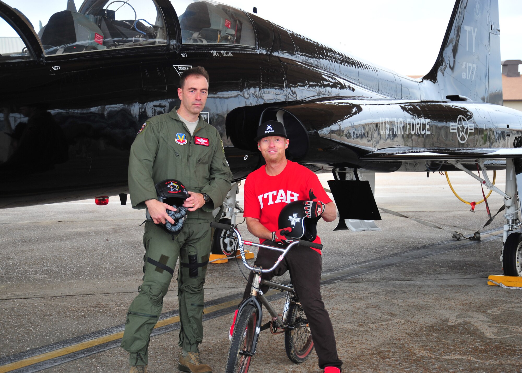 Lt. Col. Joe Granducci, 325th Training Support Squadron assistant director of operations, and his brother-in-law, Tom “Fuzzy” Hall, professional BMX rider, pose for a picture in front of Granducci’s T-38 Talon. (U.S. Air Force photo by Airman 1st Class Dustin Mullen)