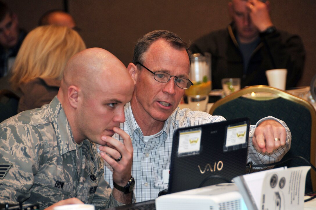 U.S. Air Force Staff Sgt. Mark Dow, 145th Security Forces Squadron and Phil Jonas, Yellow Ribbon Support Specialists for North Carolina Air National Guard review agenda during the first joint North and South Carolina Air National Guard Yellow Ribbon event held in Charlotte, N.C., November 16, 2013.  The North and South Carolina Guard’s Yellow Ribbon Program serves as a series of stepping stones to help reunite families and reacclimatize Airmen and Soldiers to the civilian world.  Through the YR Program, Airman can be assured that their families are taken care of while they are away. Events are held 30 days prior to a deploying unit and then at 30, 60, and 90 day intervals following the unit’s return.  (Air National Guard photo by Master Sgt. Patricia F. Moran/Released)