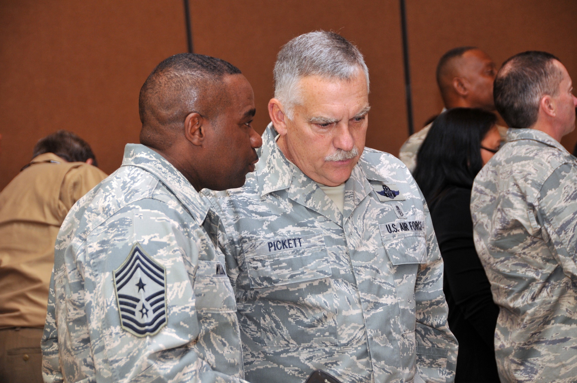 U.S. Air Force Command Chief Master Sergeant Bruce Pickett, Joint Forces Headquarters, and Command Chief Master Sgt. Maurice Williams, 145th Airlift Wing, North Carolina Air National Guard, talk over events while attending the first ever North and South Carolina ANG joint Yellow Ribbon Reintegration Program held in Charlotte, N.C., November 16, 2013.  Airmen learn about entitlements and what is available for them and their families in the member's absence. Events are held 30 days prior to a deploying unit and then at 30, 60, and 90 day intervals following the unit’s return.  (Air National Guard photo by Master Sgt. Patricia F. Moran/Released)