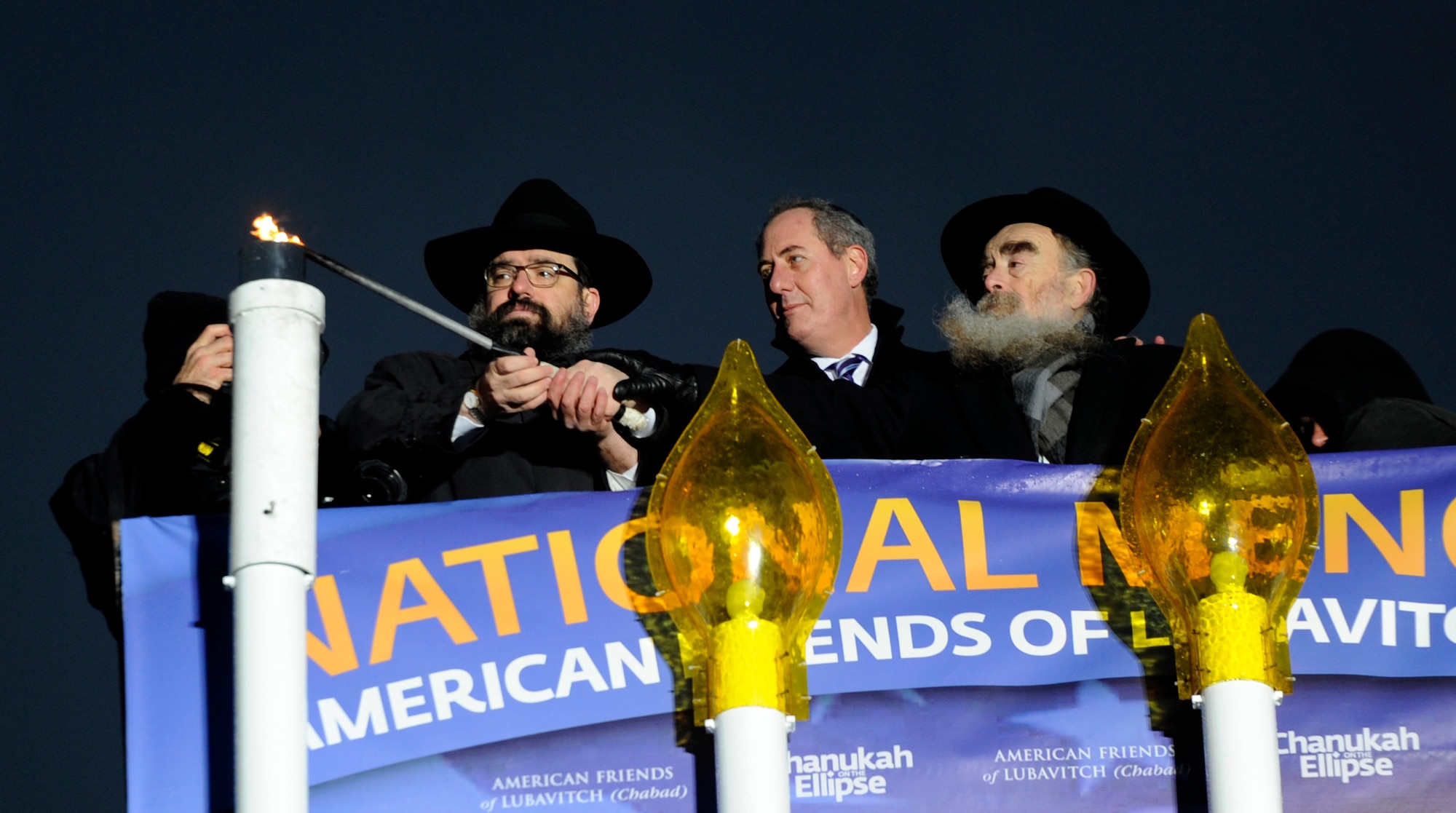 Rabbi Levi Shemtov, Hon. Michael Froman and Rabbi Abraham Shemtov light a giant menorah to mark the first night of Hanukkah, during the National Menorah Lighting at The Ellipse in Washington, D.C. on November 27, 2013. One additional candle will be lit each night through Dec. 5 to conclude the eight-day Jewish Holiday. Levi Shemtov is the executive vice president of American Friend of Lubavitch (Chabad), Froman works for the United States Trade Representative and Abraham Shemtov is the chairman, Executive Committee International Chabad Lubavitch Movement. (U.S. Air Force photo/Airman 1st Class Nesha Humes)