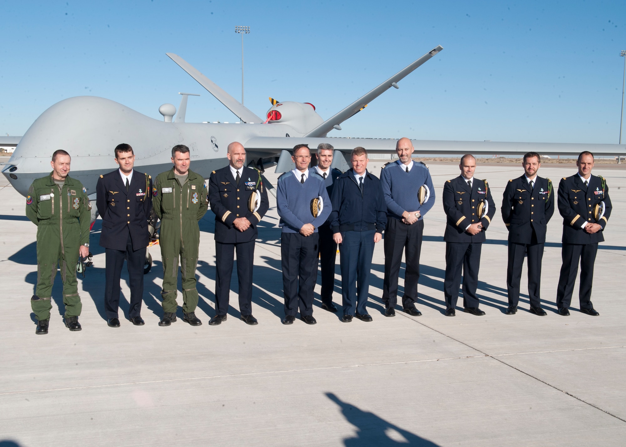 The newly- graduated French air force pilots and sensor operators stand with Colonel Andrew Croft, 49th Wing commander and Lt. Gen. Antoine Creux, French air force deputy chief of staff, in front of an MQ-9 Reaper at Holloman Air Force Base, N.M., Nov. 26. The French air force worked in collaboration with Holloman AFB to graduate six student pilots and sensor operators from the 16th Training Squadron.  The students became the first-ever French air force members to learn the MQ-9 Reaper system, and their landmark graduation will mark the beginning of future coalition efforts between France and the U.S. to better utilize Remotely Piloted Aircraft across the world. Creux visited Holloman AFB both to take part in the graduation ceremony, and to tour Holloman AFB’s MQ-9 training facilities. (U.S. Air Force phot by Airman 1st Class Daniel E. Liddicoet/Released)

