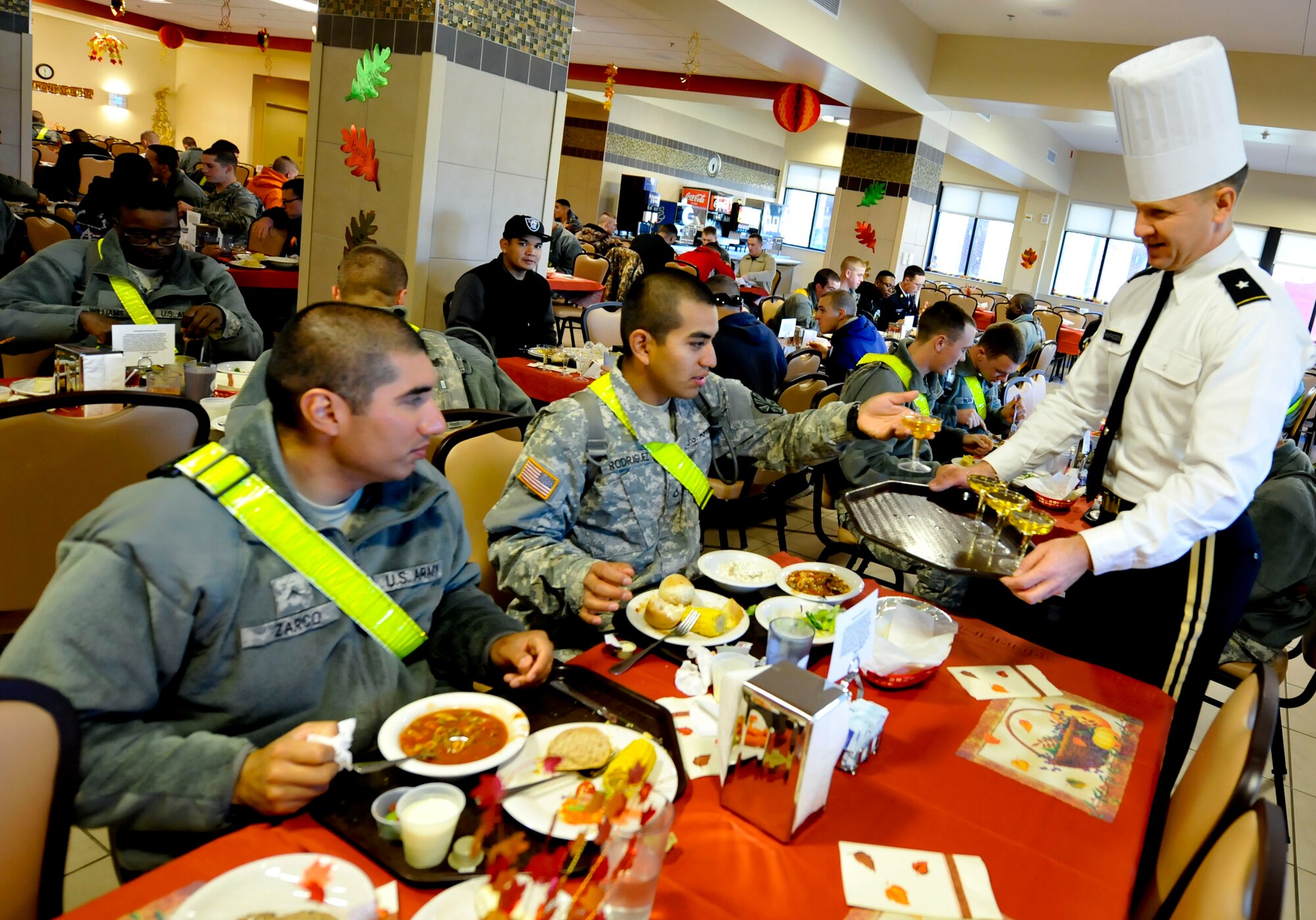 U.S. Army Brig. Gen. Christopher Mcpadden, right, U.S. Army Capability Requirements and Integration Command director of concept development and learning, serves glasses of sparkling juice to Soldiers during a Thanksgiving dinner at Fort Eustis, Va., Nov. 28, 2013.  As part of a continued tradition, Fort Eustis’ leadership serves holiday meals to Soldiers who are unable to go home for the holidays. (U.S. Air Force photo by Staff Sgt. Wesley Farnsworth/Released)