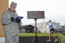 YOUNGSTOWN AIR RESERVE STATION, Ohio—U.S. Air Force Reserve Master Sgt. Nathan Moffitt, a metals technician for the 910th Aerial Maintenance Squadron, records run times for Airmen performing their Fit-to-Fight assessment at the base running track Nov. 11, 2013 here. The Fit-to-Fight assessment ensures Airmen are combat ready, and must be passed annually or bi-annually, depending on performance results. (U.S. Air Force photo/TSgt. Jim Brock). 