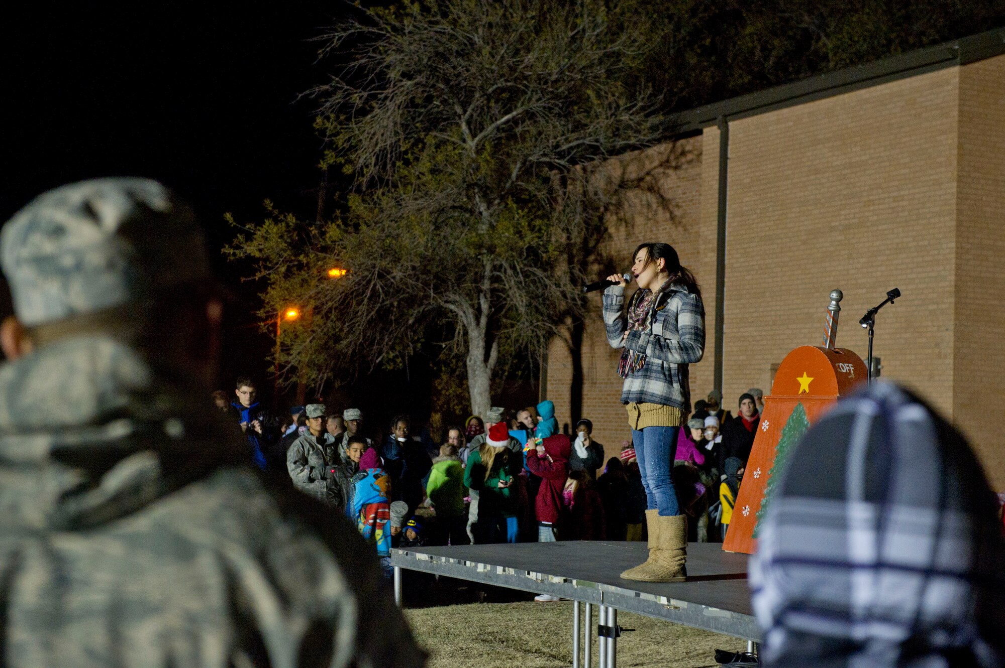 Savannah Berry, a former contestant on The Voice, performs at the annual Christmas tree and Menorah lighting ceremony at Holloman Air Force Base N.M., Nov. 22. Berry also performed at the 49th Wing holiday party later that evening.(U.S. Air Force photo by Airman 1st Class Chase Cannon/Released)