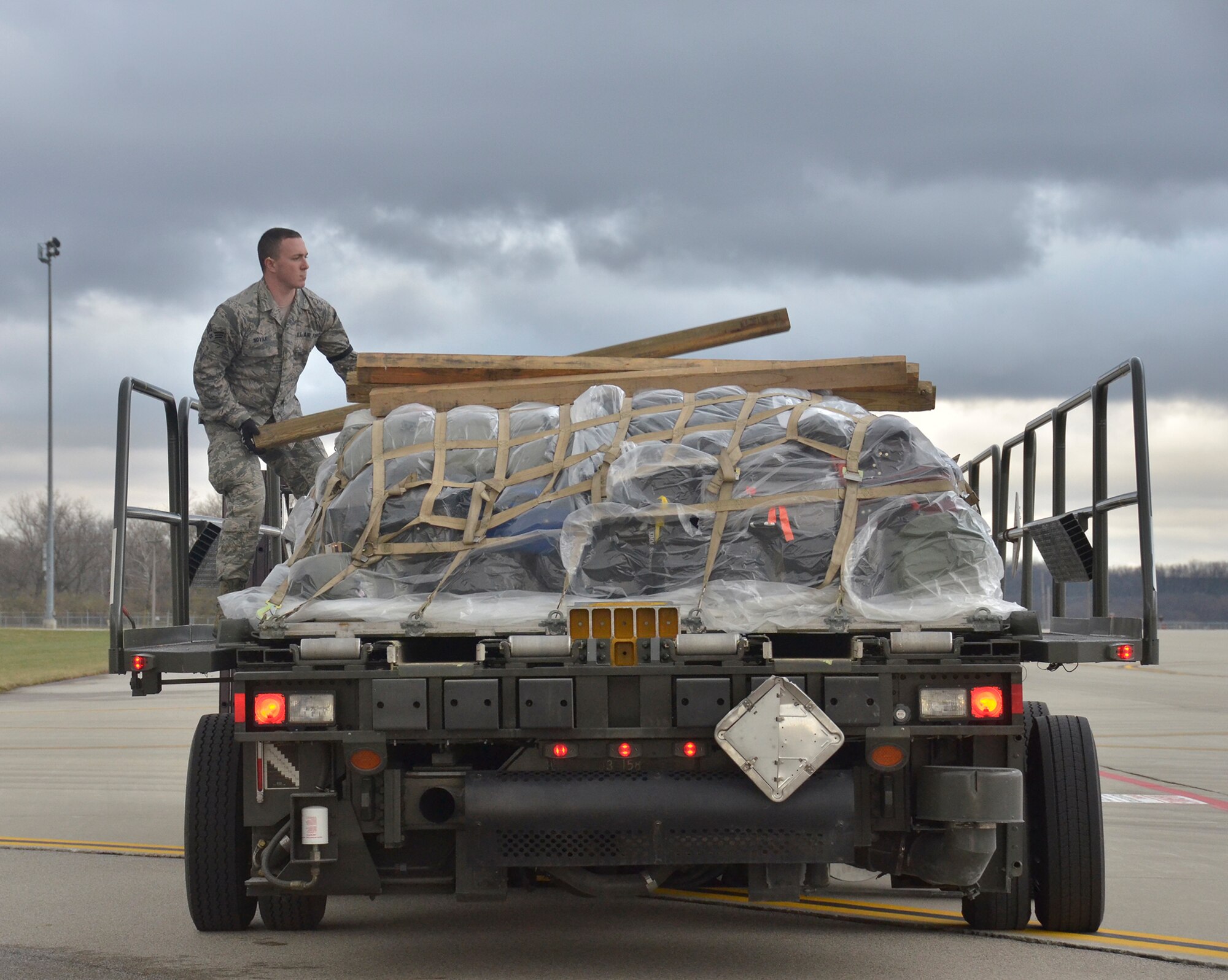 WRIGHT-PATTERSON AIR FORCE BASE, Ohio - Senior Airman Cody Novak, 87th Aerial Port Squadron, secures cargo onto the back of a K-Loader Nov. 17 after unloading a 445th Airlift Wing C-17 Globemaster III dropping of wing reservists who participated in water survival training at Naval Air Station in Key West, Fla. (U.S. Air Force photo/Staff Sgt. Amanda Duncan)