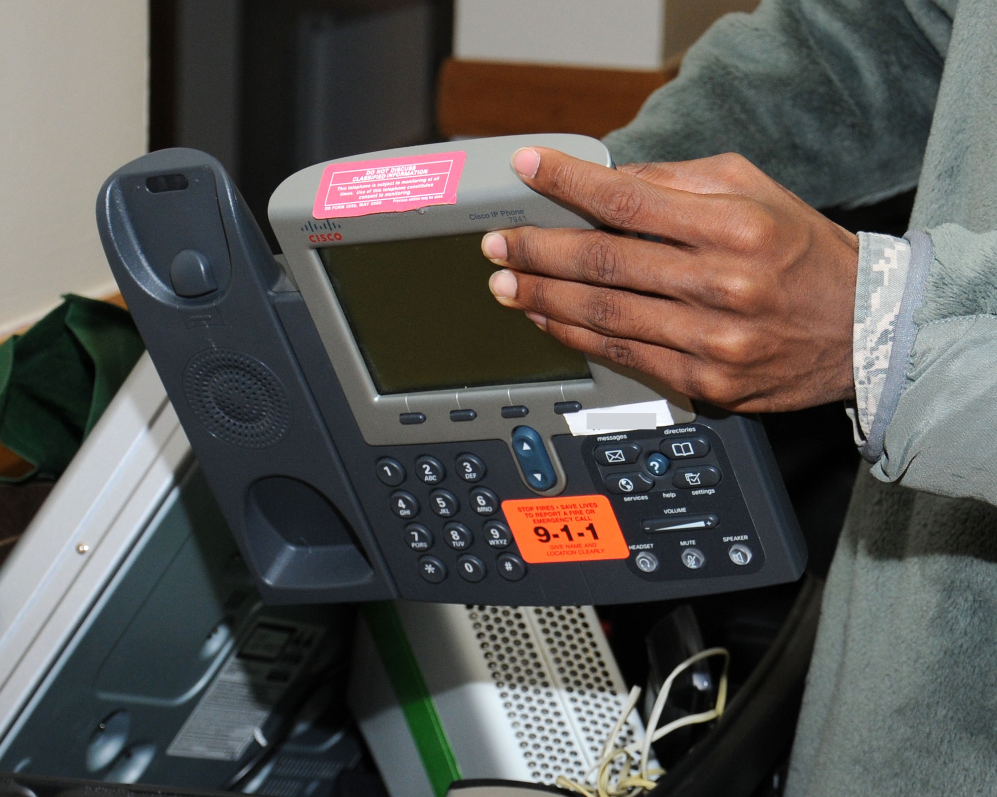 U.S. Air Force Airman 1st Class Tony Moorer, 100th Operations Support Squadron Aviation Resource Management apprentice from Detroit, organizes electronic equipment donated from the base chapel after it was moved to dormitory 215 for the ground floor dayroom Nov. 26, 2013, on RAF Mildenhall, England. The furniture was moved to make a lounge for the Airmen Against Drunk Driving volunteers while on duty. The 100th Civil Engineer Squadron manages six dormitories, with dormitory 111 currently under renovation. (U.S. Air Force photo by Gina Randall/Released)