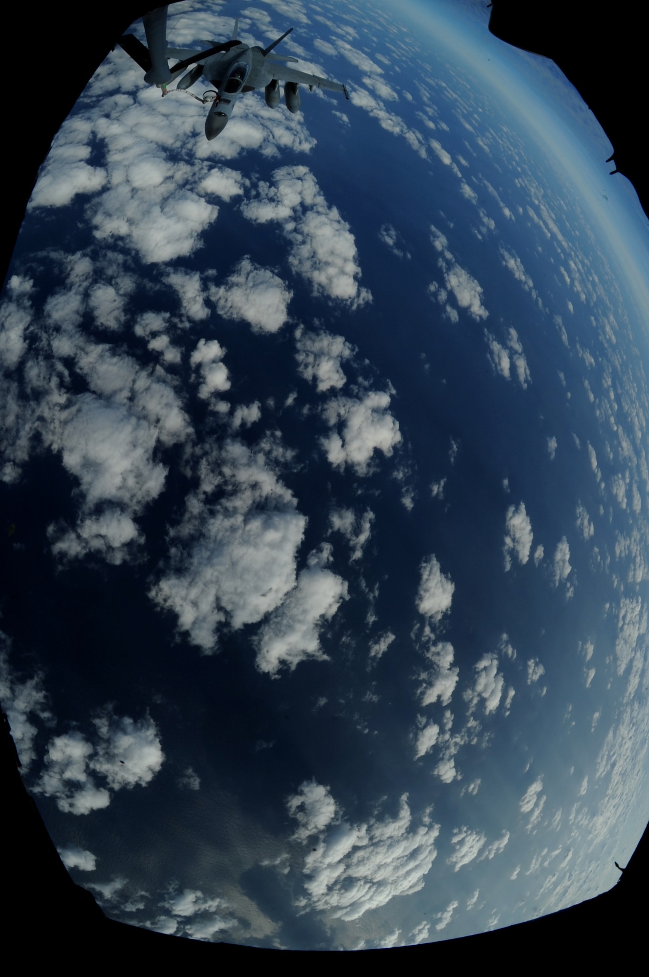 A U.S. Navy F/A-18 Super Hornet receives fuel from a KC-135 Stratotanker from Kadena Air Base, Japan, during a joint training exercise in the Asian-Pacific region, Nov. 26, 2013. The exercise consisted of multiple F/A-18 Super Hornets, stationed on the USS George Washington aircraft carrier being refueled by a KC-135 Stratotanker with a drogue adapter attached to boom, which is capable of off-loading 1,000 pounds of fuel per minute.  (U.S. Air Force photo by Airman 1st Class Keith James)