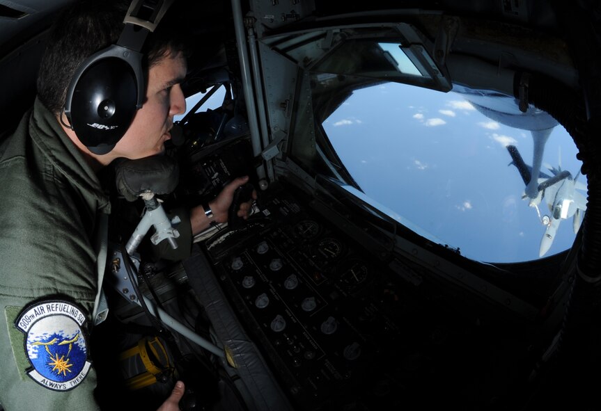 U.S. Air Force Staff Sgt. Jason Duckett, 909th Air Refueling Squadron boom operator, refuels a U.S. Navy F/A-18 Super Hornet during a joint training exercise in the Asian-Pacific region, Nov. 26, 2013. Approximately 200,000 pounds can be pumped through the aircraft?s boom, a rigid, telescoping tube equipped with a drogue adapter and movable flight control surfaces that an operator controls. (U.S. Air Force photo by Airman 1st Class Keith James)