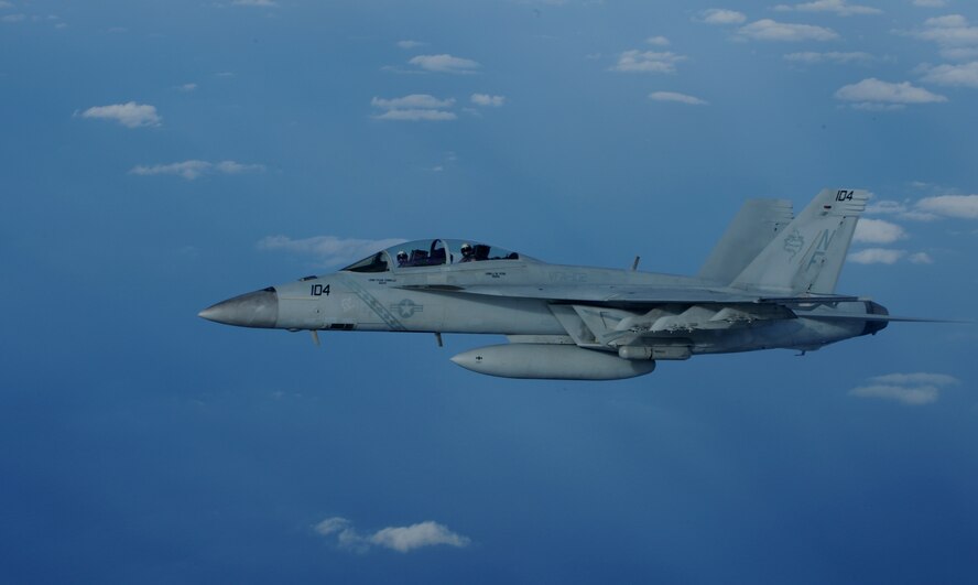 A U.S. Navy F/A-18 Super Hornet flies in the Asia-Pacific region during a joint refueling training exercise with a KC-135 Stratotanker from Kadena Air Base, Japan, Nov. 26, 2013. The Super Hornet is an attack aircraft as well as a fighter through selected use of external equipment and advanced networking capabilities to accomplish specific missions. In its fighter mode, it serves as escort and fleet air defense. In its attack mode, it provides force projection, interdiction, and close and deep air support. (U.S. Air Force photo by Airman 1st Class Keith James)