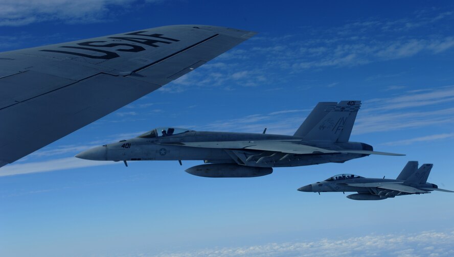 Two U.S. Navy F/A-18 Super Hornets fly alongside a KC-135 Stratotanker from Kadena Air Base, Japan during a joint exercise over the Asia-Pacific region, Nov. 26, 2013. The Super Hornet is an attack aircraft as well as a fighter through selected use of external equipment and advanced networking capabilities to accomplish specific missions. In its fighter mode, it serves as escort and fleet air defense. In its attack mode, it provides force projection, interdiction, and close and deep air support. (U.S. Air Force photo by Airman 1st Class Keith James)