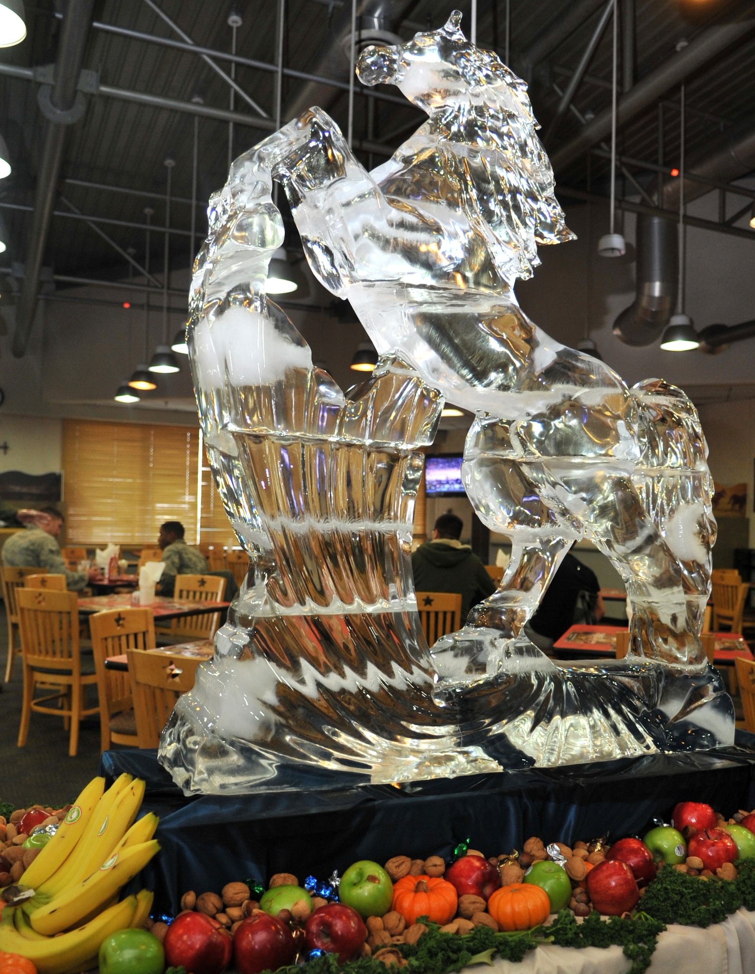 A Mustang ice sculpture towers over the seating area during the Thanksgiving meal in the Gingko Tree dining facility at Osan Air Base, Republic of Korea, Nov. 28, 2013. The Mustang, along with a receiving line of Osan leadership and volunteers dressed in traditional Korean garb welcomed diners as they entered the Gingko Tree. (U.S. Air Force photo/Airman 1st Class Ashley J. Thum)