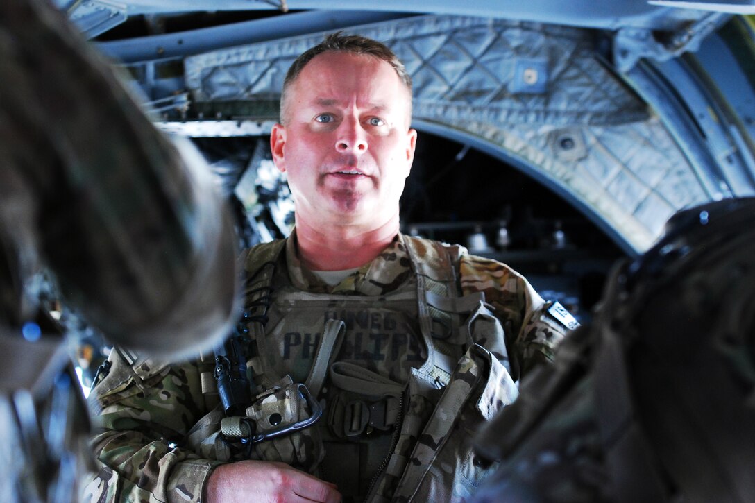 U.S. Army Chief Warrant Officer 5 Doug Phillips briefs his helicopter crew on Bagram Airfield, Afghanistan, Nov. 27, 2013. Phillips is a pilot assigned to the 3rd Battalion General Support, 10th Combat Aviation Brigade, Task Force Phoenix, and is deployed from the Texas National Guard.