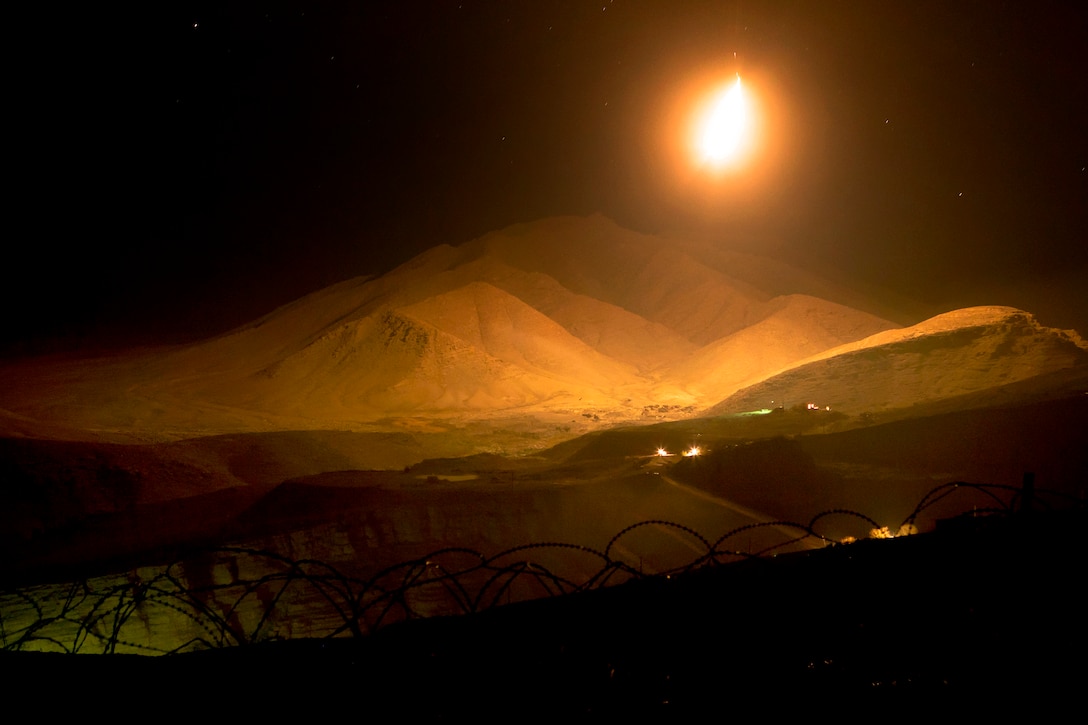 An illumination flare lights up a mountain near Observation Post Athens in Afghanistan's Helmand province, Nov. 27, 2013. A squad of Marines assigned to 3rd Battalion, 7th Marine Regiment provided security from the outpost, where they had an unobstructed view of their surroundings.