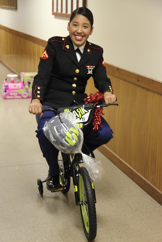 Lance Cpl. Karen Hernandez rides a bicycle during the Toys for Tots Senior Dance Nov. 16 at the Knights of Columbus facility in New Bern. Hernandez is an air support operations Marine with Marine Air Support Squadron 1.  During the event the Marines helped collect toys and raise awareness about the program.


 