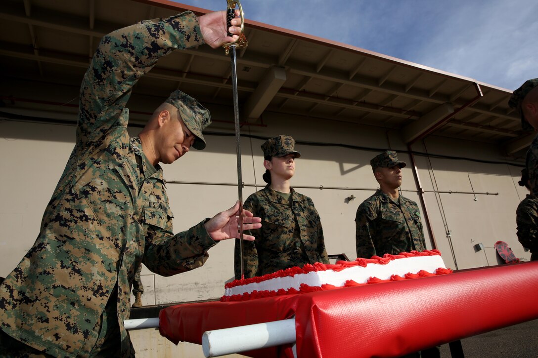 Lt. Col. John DeLateur, left, Marine Aviation Logistics Squadron (MALS) 11 commanding officer, cuts the cake during a cake-cutting ceremony celebrating MALS-11’s 92nd anniversary aboard Marine Corps Air Station Miramar, Calif., Dec. 2. The squadron works diligently in support of fixed-wing aircraft as it has for the past 92 years.