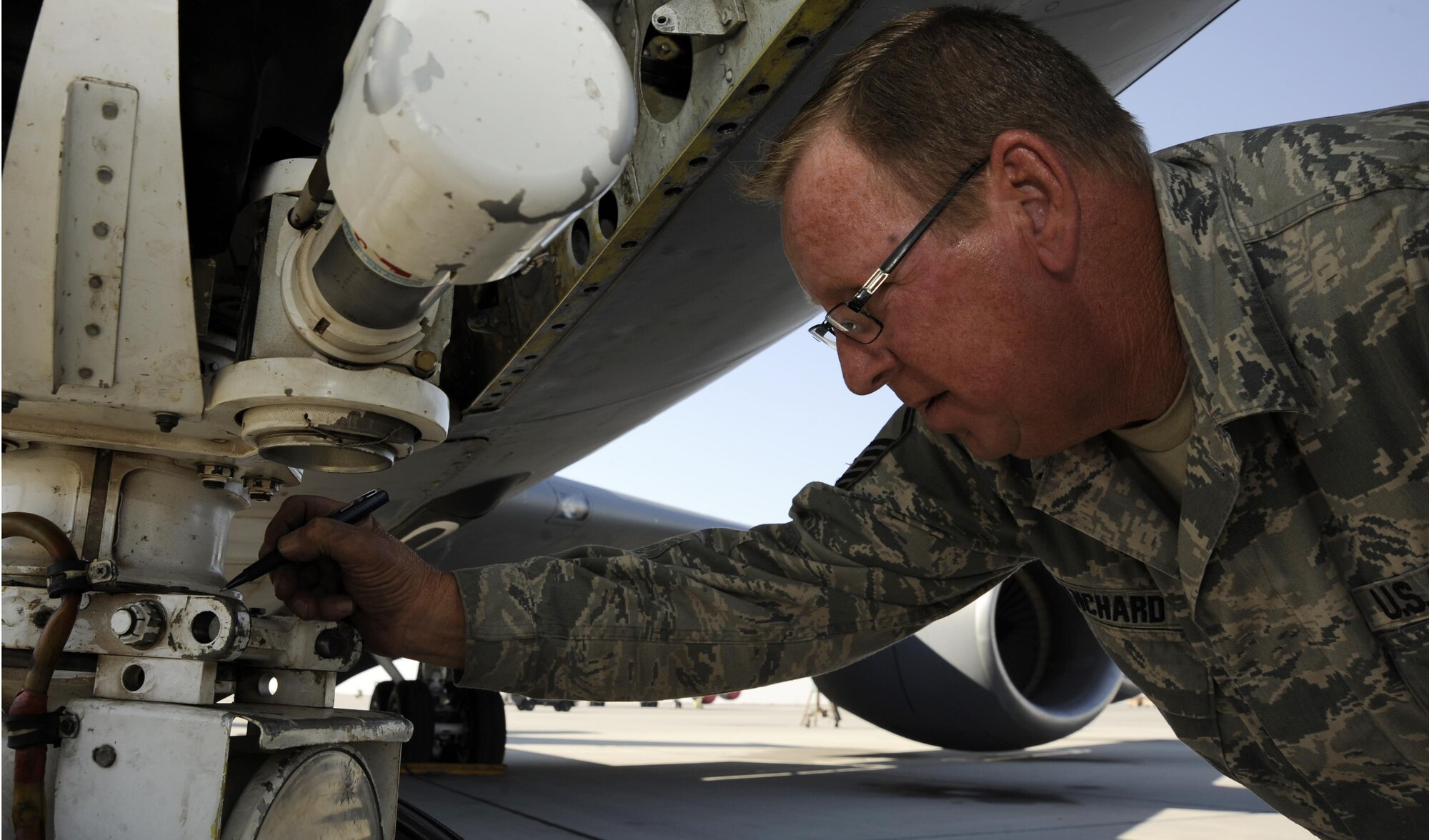 Master Sgt. Timothy Blanchard marks the nose wheel steering travel during an operations check after reinstallation on a KC-135 Stratotanker Nov. 26, 2013, at the 379th Air Expeditionary Wing in Southwest Asia. The aero repair shop has performed more than 350 major aircraft repairs this year, saving the Air Force money in maintenance and estimated shipping costs. Blanchard is a 379th Expeditionary Maintenance Squadron repair and reclamation technician.