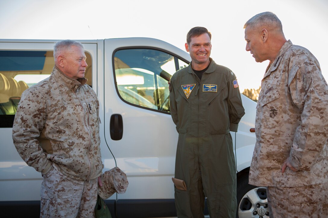 The Assistant Commandant of the Marine Corps, Gen. John M. Paxton, Jr., right, and Lt. Gen. Kenneth Glueck, left, speak with Captain Christopher Dennis aboard Naval Air Station Sigonella, Italy, Nov. 26, 2013. (U.S. Marine Corps photo by Cpl. Tia Dufour/Released)