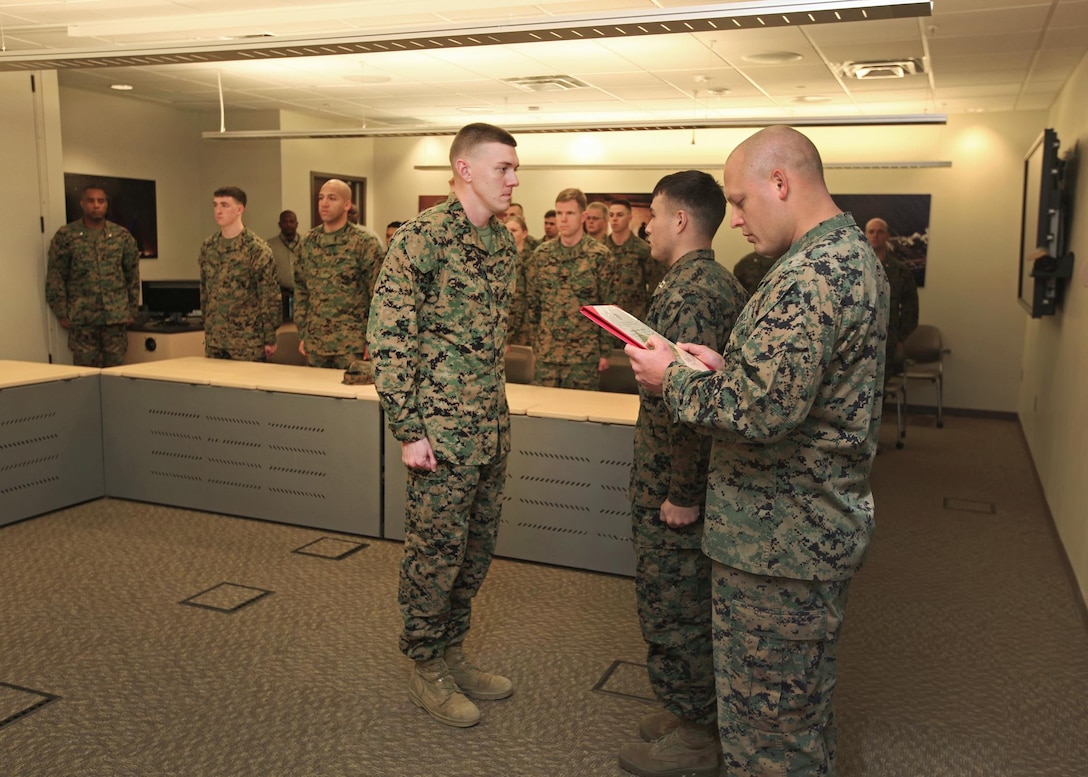 Marines and Civilians of the Marine Corps Information Operations Center gather to promote Cpl Russell D. Harned to the rank of Sergeant. Sergeant Harned was pinned on by Mr. Jonathan M. Storment and GySgt John C. Tyson. (U.S. Marine Corps photo by Sgt Kristofer Atkinson)