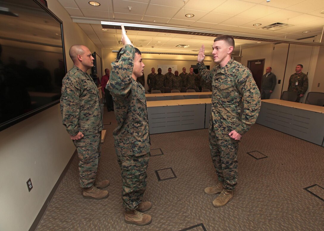 Marines and Civilians of the Marine Corps Information Operations Center gather to promote Cpl Russell D. Harned to the rank of Sergeant. Sergeant Harned was pinned on by Mr. Jonathan M. Storment and GySgt John C. Tyson. (U.S. Marine Corps photo by Sgt Kristofer Atkinson)