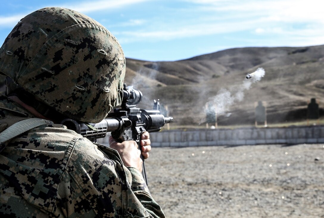 Sergeant Justin Maggard, logistics management coordinator, 15th Marine Expeditionary Unit, engages a target with his M4A1 during a small-arms training exercise at Range 111 aboard Camp Pendleton, Calif., Nov. 25. The training focused on enhancing the unit’s confidence and proficiency with personal weapons and M67 Fragmentation Hand Grenades. (U.S. Marine Corps photo by Cpl. Emmanuel Ramos)