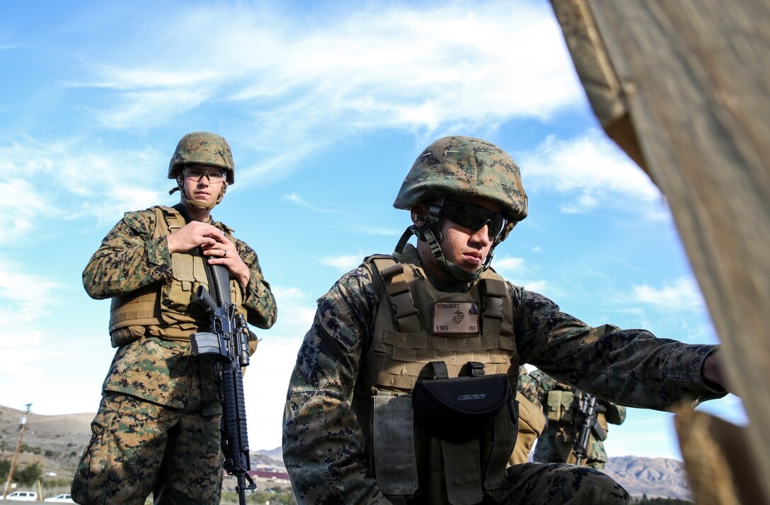 Corporal Richard Hernandez, right, data network specialist, 15th Marine Expeditionary Unit, helps Lance Cpl. Brian Flanagan, radio operator, 15th MEU, attain his battle-sight zero by assessing shots on target during a small-arms training exercise at Range 111 aboard Camp Pendleton, Calif., Nov. 25. The training focused on enhancing the unit’s confidence and proficiency with personal weapons and M67 Fragmentation Hand Grenades. Hernandez, 22, is from Temecula, Calif. Flanagan, 23, is from Columbus, Ohio. (U.S. Marine Corps photo by Cpl. Emmanuel Ramos)
