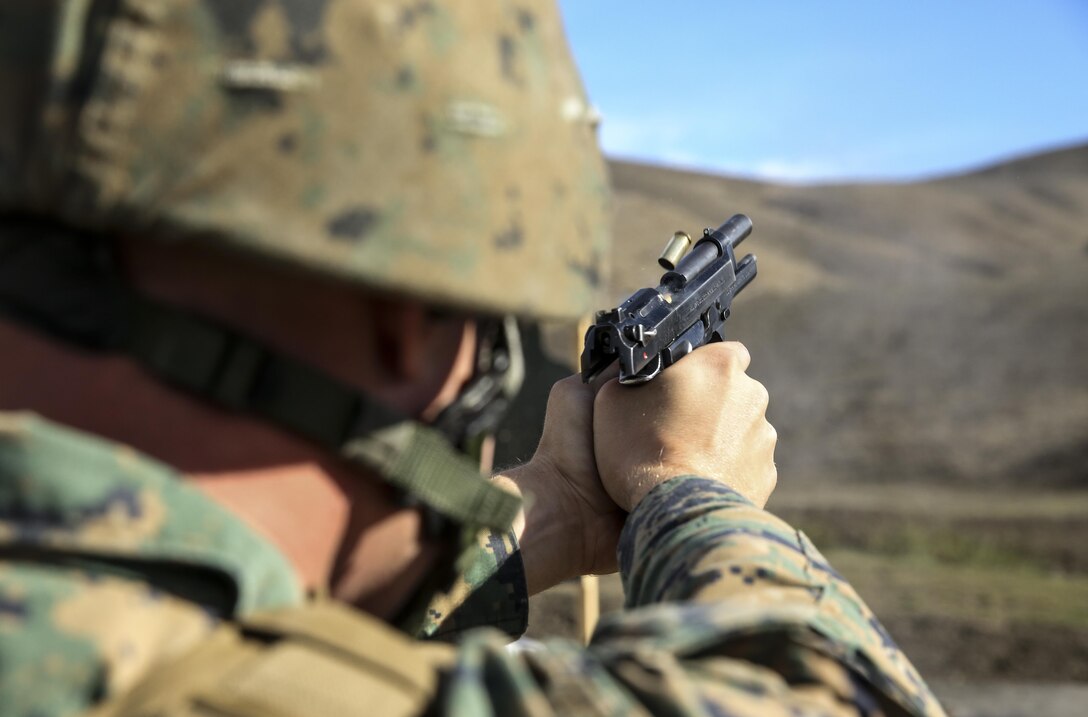 Sergeant Chester P. Ginter, motor transport mechanic, 15th Marine Expeditionary Unit, fires an M9 pistol at a target during a small-arms training exercise at Range 111 aboard Camp Pendleton, Calif., Nov. 25. The training focused on enhancing the unit’s confidence and proficiency with personal weapons and M67 Fragmentation Hand Grenades. Ginter, 24, is from Ketchikan, Alaska. (U.S. Marine Corps photo by Cpl. Emmanuel Ramos)