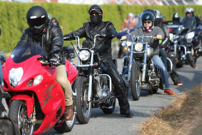 Motorcycle riders arrive aboard Marine Corps Air Station Iwakuni, Japan, to help support the Motorcycle Rally and Toy Drive event hosted by the Marine Thrift Store, Nov. 24, 2013. After donating their toys, motorcycle riders took a lap around base in celebration of the event.
