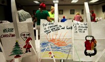 Empty bags, decorated by local elementary school students and Girl Scouts, wait to be filled with cookies during the annual Cookie Caper event Dec. 3, 2013. The cookies are distributed to single Airmen living in the base dormitories. The cookie drive collected 16,176 cookies and distributed bags to more than 1,300 Airmen. (U.S. Air Force photo/Staff Sgt. Alexander Martinez)