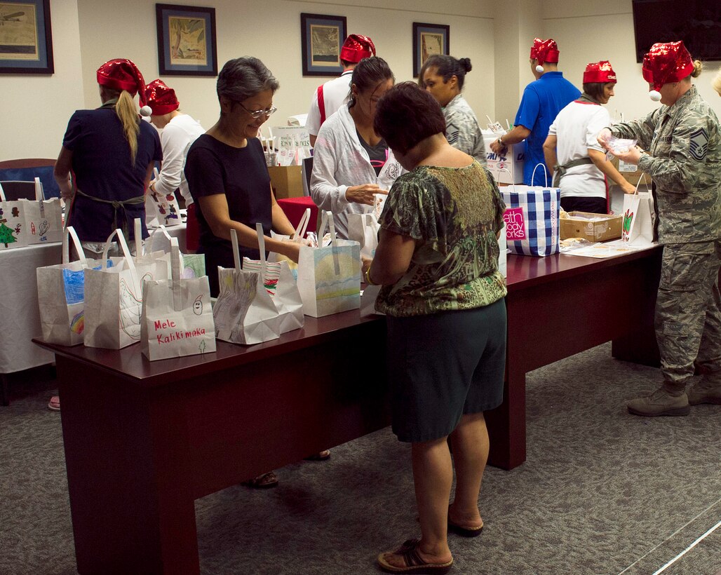 Cookie Caper “elves” collect and sort cookies in holiday-themed bags during the annual Cookie Caper event Dec. 3, 2013. The cookies are distributed to single Airmen living in the base dormitories. The cookie drive collected 16,176 cookies and distributed bags to more than 1,300 Airmen. (U.S. Air Force photo/Staff Sgt. Alexander Martinez)
