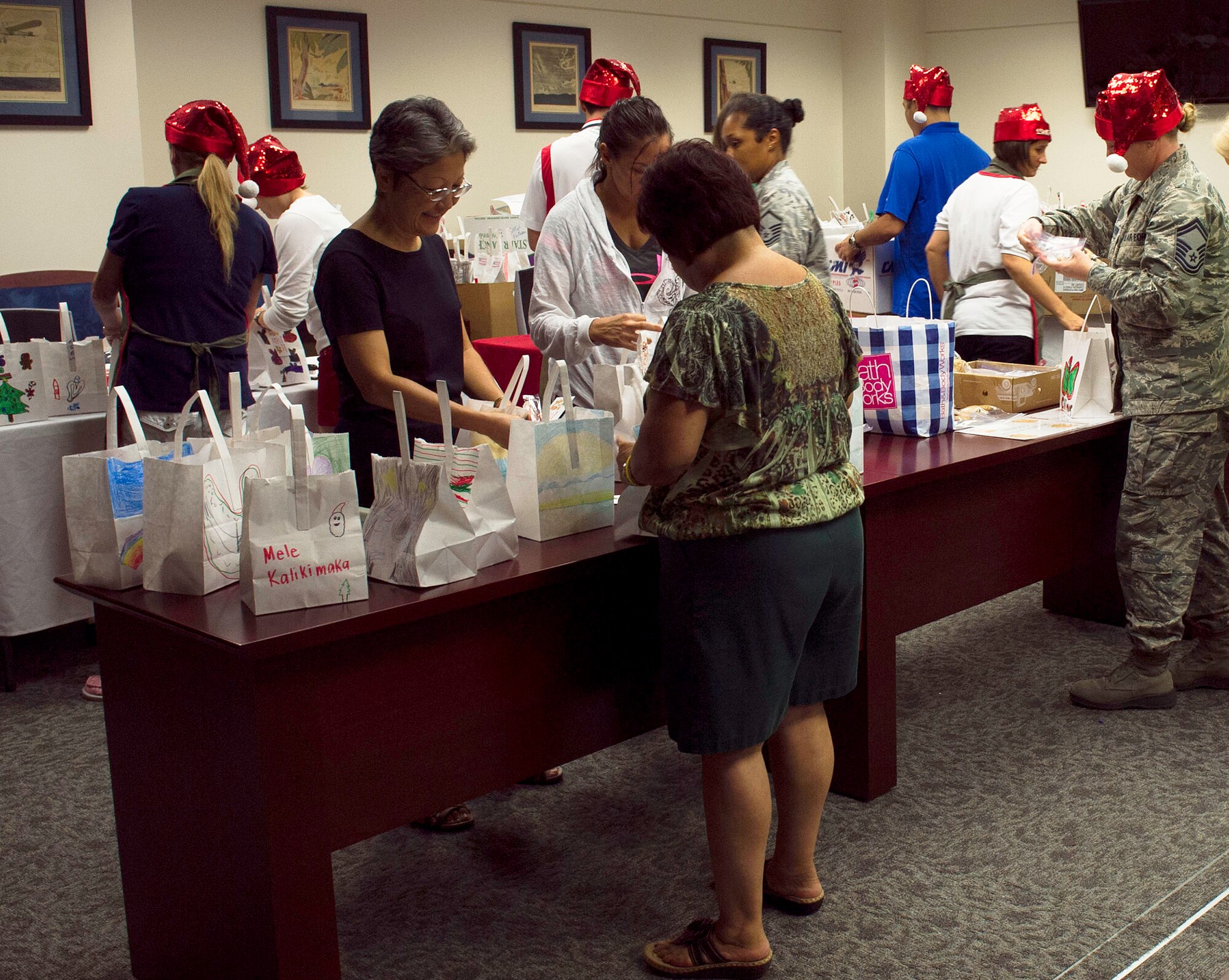 Cookie Caper “elves” collect and sort cookies in holiday-themed bags during the annual Cookie Caper event Dec. 3, 2013. The cookies are distributed to single Airmen living in the base dormitories. The cookie drive collected 16,176 cookies and distributed bags to more than 1,300 Airmen. (U.S. Air Force photo/Staff Sgt. Alexander Martinez)
