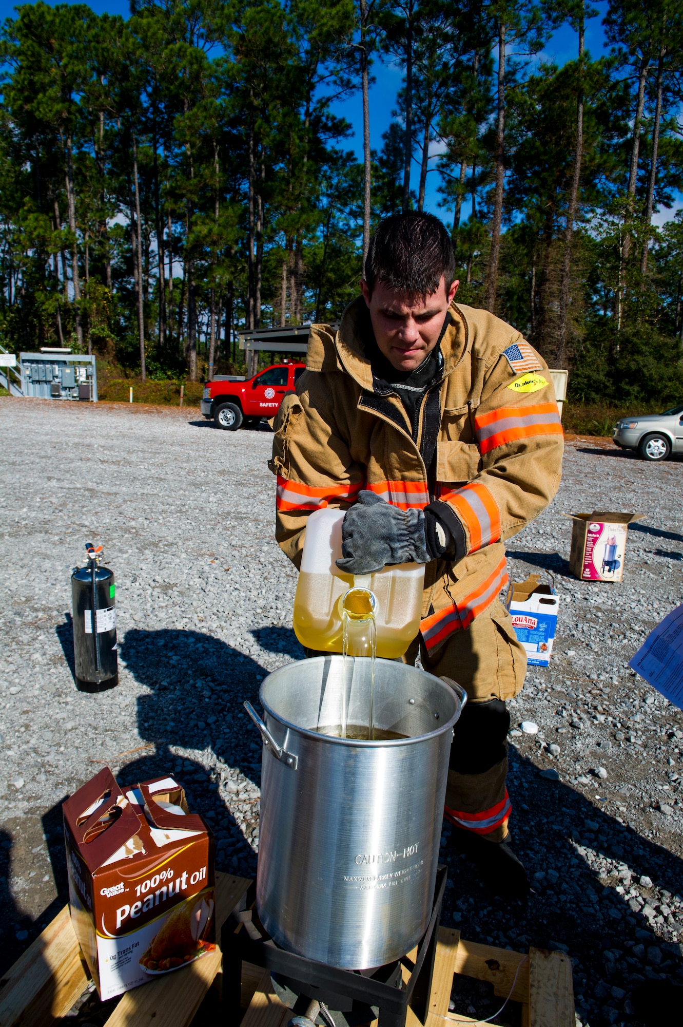 Staff Sgt Glenn Rodgers, 1st Special Operations Civil Engineer Squadron fire inspector, fills a turkey fryer with cooking oil during a safety demonstration at the fire training area on Hurlburt Field, Fla., Nov. 27, 2013. Deep-frying turkeys has recently grown in popularity and the tradition prompts fire safety concerns. (U.S. Air Force photo/Senior Airman Christopher Callaway)