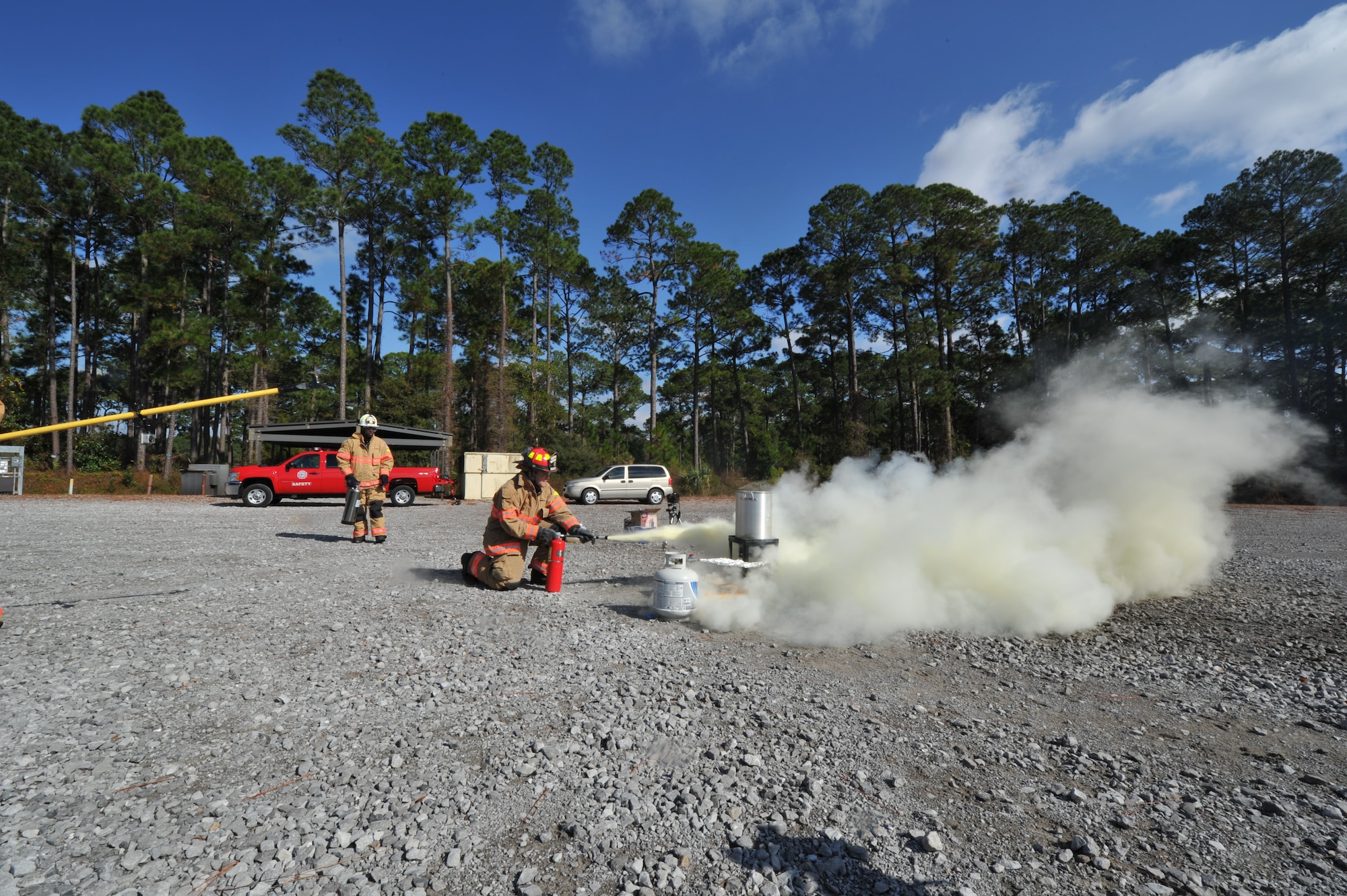 Staff Sgt. Glenn Rodgers, 1st Special Operations Civil Engineer Squadron fire inspector, sprays down a fire with a Class K fire extinguisher during a safety demonstration at the fire training area on Hurlburt Field, Fla., Nov. 27, 2013. Only Class ABC fire extinguishers, Class K fire extinguishers or baking powder should be used to put out grease fires. (U.S. Air Force photo/Staff Sgt. John Bainter)