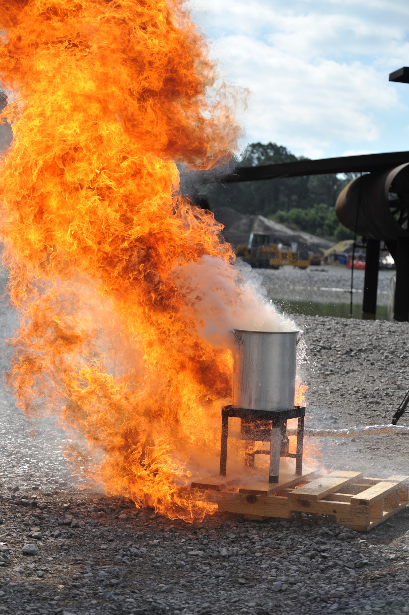 A raging fire occurs after a frozen turkey is placed in an over filled turkey fryer during a safety demonstration at the fire training area on Hurlburt Field, Fla., Nov. 27, 2013. Ensuring turkeys are thawed, slowly eased into the fryer, and not over filling fryers with oil can prevent potential fires. (U.S. Air Force photo/Staff Sgt. John Bainter)