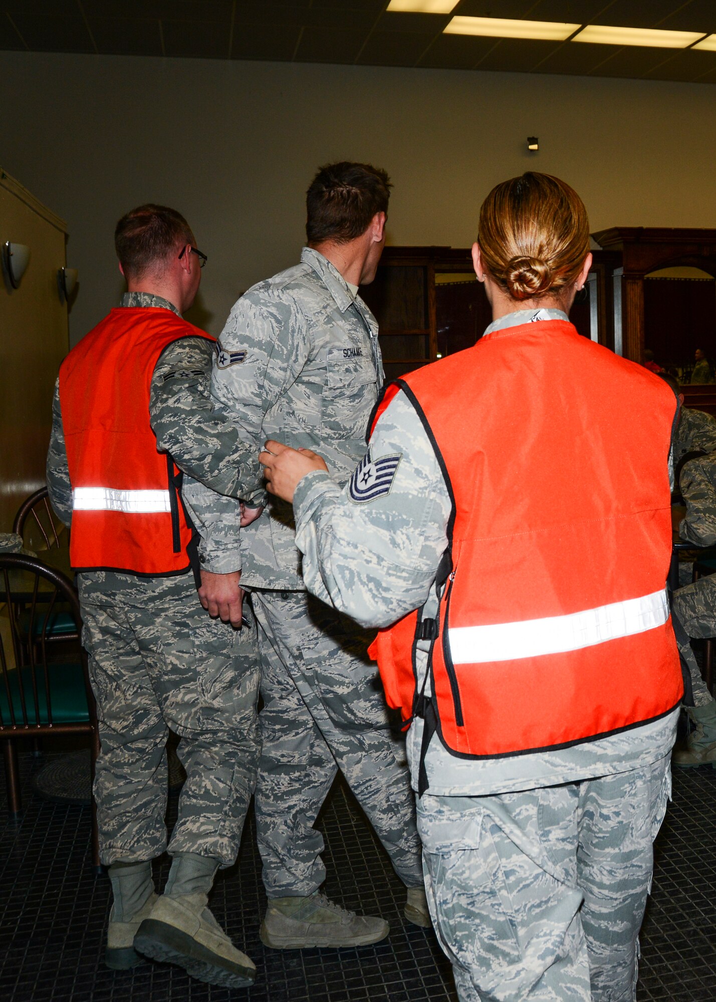 An unruly patient is escorted back to the first checkpoint after disregarding the flow of traffic in the POD. (U.S. Air Force photo by Rebecca Amber)