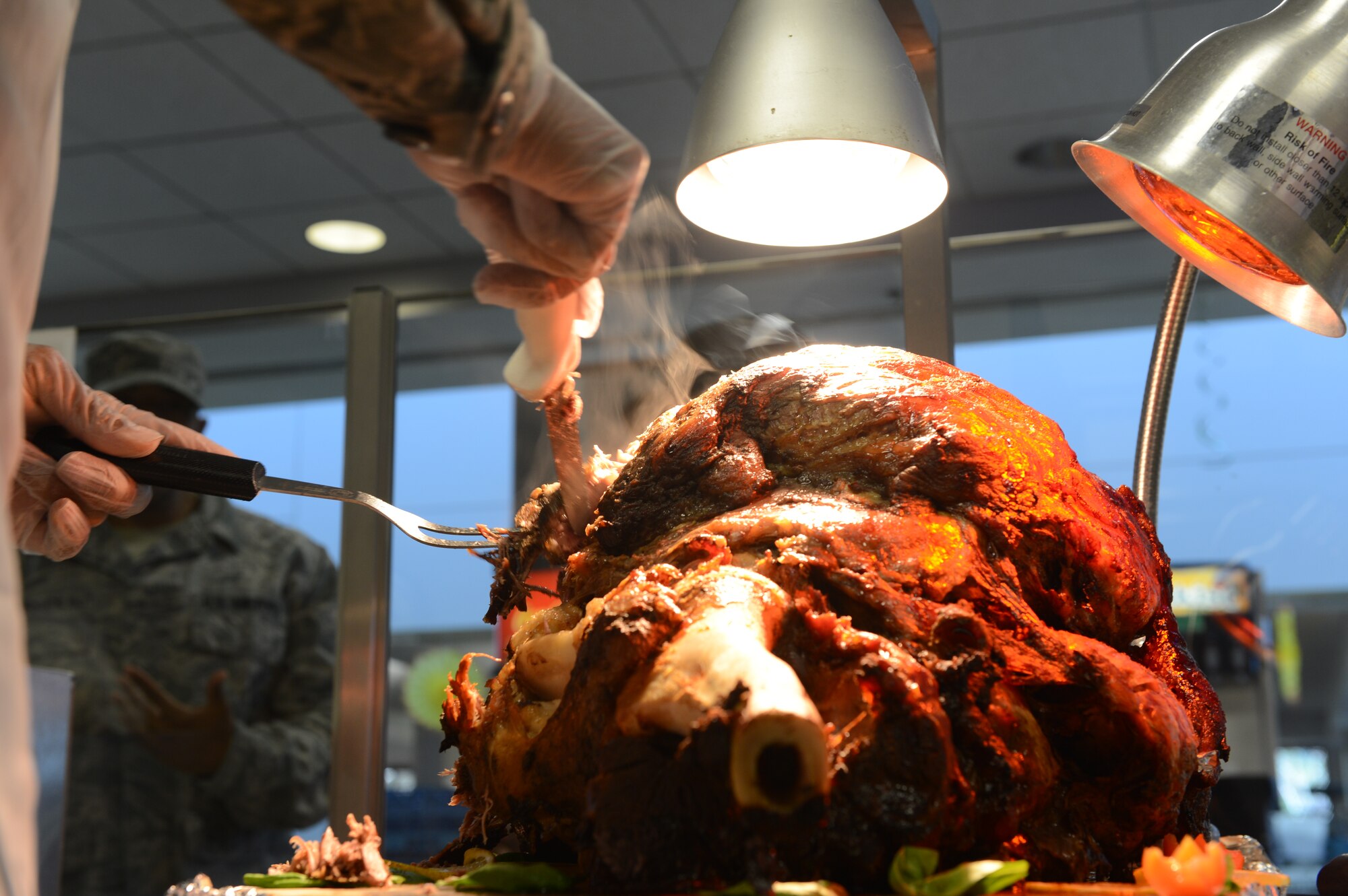 U.S. Air Force Chief Master Sgt. Thomas Leggett, 20th Logistics Readiness Squadron chief enlisted manager, cuts into a turkey at the Chief Master Sergeant Emerson E. Williams Dining Facility, Nov. 28, 2013, Shaw Air Force Base, S.C. Leggett carved the turkey for Airmen who  were present at the dining facility for their Thanksgiving Day meal. (U.S. Air Force photo by Tech. Sgt. Frank Miller/Released)