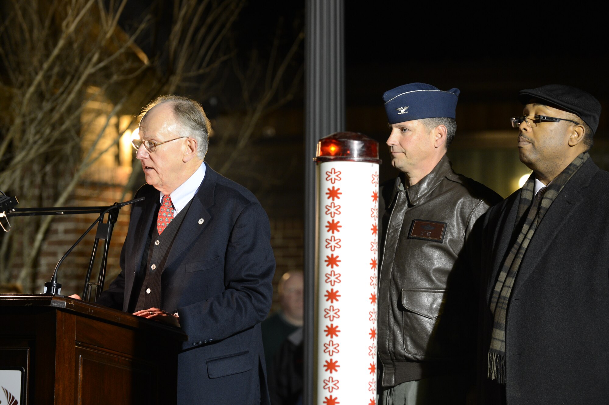 Sumter, S.C., Mayor Joseph T. McElveen Jr. speaks at the Fantasy of Lights event with Col. Clay Hall, 20th Fighter Wing commander, and Rev. Dr. Kenneth Smith, Tuomey Healthcare Chaplaincy Service Department, in attendance at Swan Lake Iris Gardens, Sumter, S.C., Dec. 1, 2013. McElveen welcomed attendees to the 26th annual event that featured the 34th annual Pilot Club’s floating Christmas tree. (U.S. Air Force photo by Tech. Sgt. Frank Miller/Released)