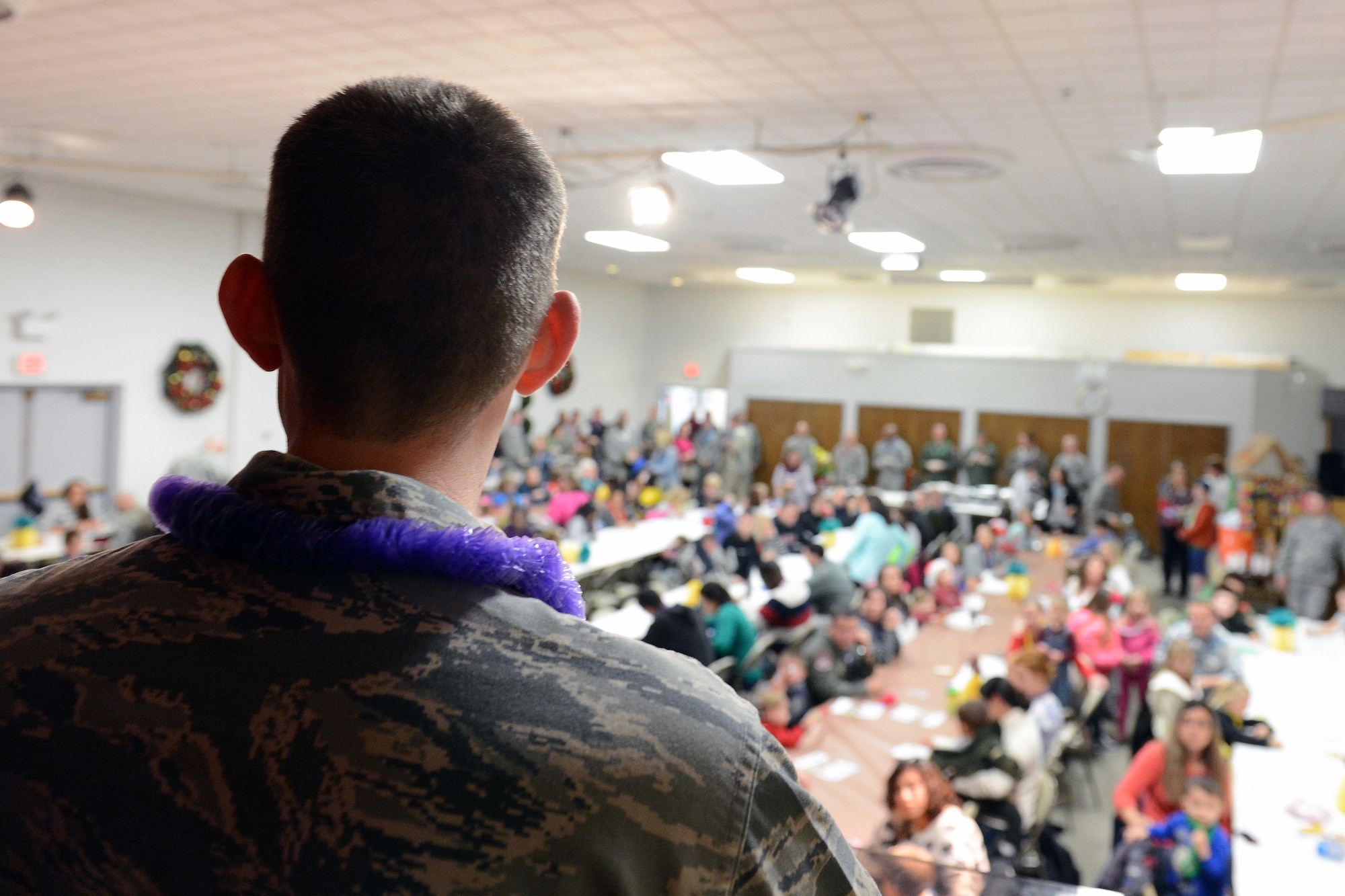 1st Lt. Ryan Neil, 627th Air Base Group Chaplain, welcomes families to the quarterly deployed families dinner Dec. 2, 2013, following the tree lighting ceremony at Joint Base Lewis-McChord, Wash. Families enjoyed food, door prizes and live Hawaiian music and dance performances. (U.S. Air Force photo/Airman 1st Class Jacob Jimenez)   