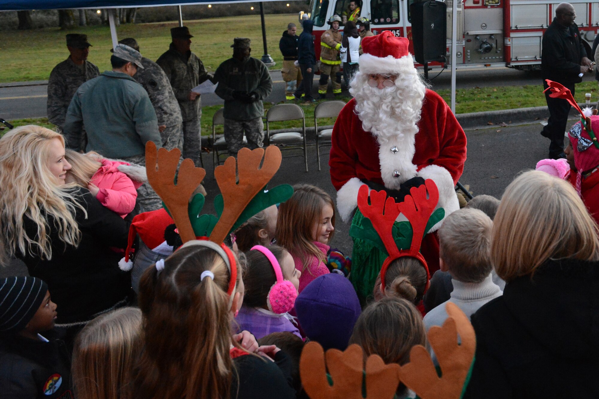 Santa Claus is greeted with hugs from children, Dec. 2, 2013, at the annual tree lighting ceremony at Joint Base Lewis-McChord, Wash. Kids received candy canes from Santa and were added to his ‘Nice’ list. (U.S. Air Force photo/Airman 1st Class Jacob Jimenez)  