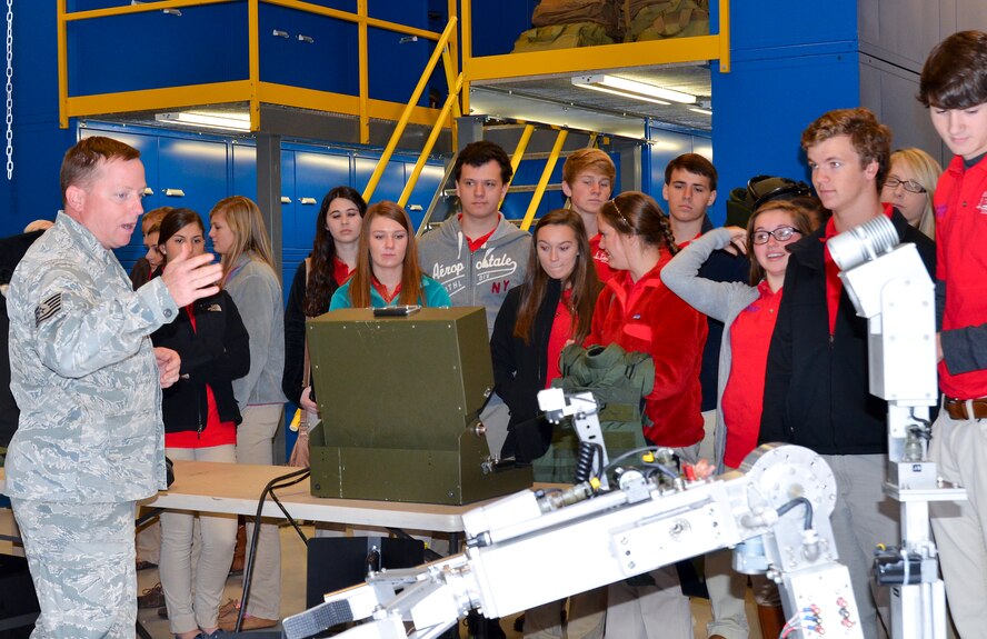 U.S. Air Force Tech. Sgt. Barry Duffield, 116th Air Control Wing explosive ordnance disposal (EOD) technician, Georgia Air National Guard, demonstrates a robot used during ordnance disposal operations to students from Perry Youth Leadership who visited the EOD shop during a tour of Robins Air Force Base, Ga., Dec. 3, 2013. During the tour, Duffield and other EOD technicians showed the students some tools of the trade and spoke with them about their mission both at home and abroad. (U.S. Air National Guard photo by Tech. Sgt. Regina Young/Released) 