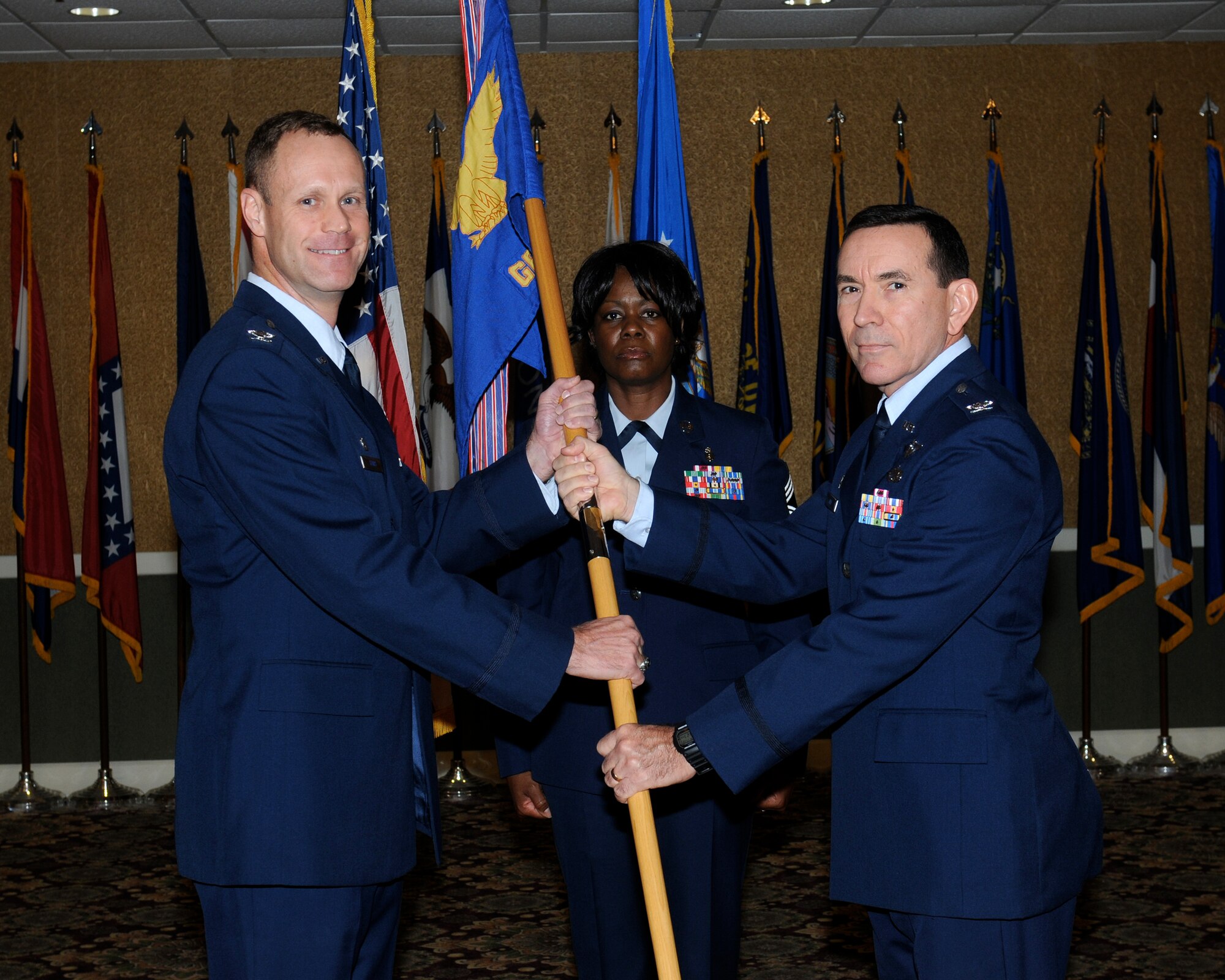 Col. Jim Sears, 14th Flying Training Wing Commander, passes the Medical Group guidon to Col. Allen Kidd, incoming 14th Medical Group Commander, at assumption of command ceremony Nov. 22 at the Columbus Club.  Kidd previously came from the 43rd Aeromedical Evacuation Squadron at Pope Army Airfield in North Carolina where he was the Commander of a unit that mobilizes and deploys specially trained, fully equipped, medical and communications forces, capable of establishing and operating critical components of the Department of Defense’s Theater Aeromedical Evacuation System in response to and support of any homeland or overseas contingency or steady state operation.
 (U.S. Air Force Photo/Melissa Dublin)