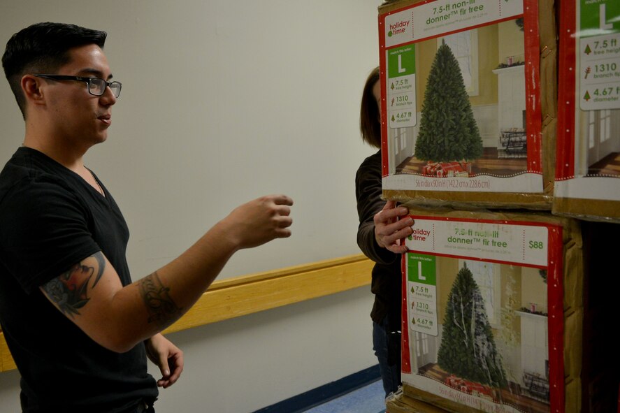 U.S. Air Force Airman 1st Class Michael Chappell, 20th Aerospace Medicine Squadron public health journeyman, examines and counts up the boxes stacked in the hallway at Tuomey Hospital, Sumter, S.C. Dec. 1, 2013. Volunteers helped set up and decorate trees for the festival of trees at Tuomey Hospital. (U.S. Air Force photo by Senior Airman Ashley L. Gardner/ Released)