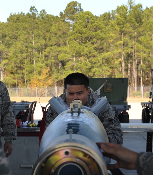 U.S. Air Force Senior Airman Vattanak Kang, 23d Equipment Maintenance Squadron munitions systems technician, checks the alignment of a forward adapter at Moody Air Force Base, Ga., Dec. 2, 2013. Airmen of the 23d EMS demonstrated the bomb-building process to the 23d Wing leadership. (U.S. Air Force photo by Senior Airman Olivia Bumpers/Released)