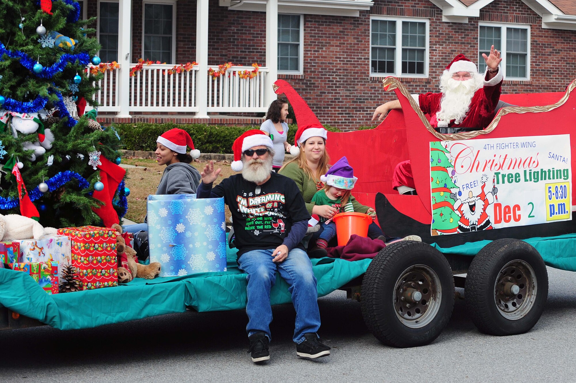 A float passes through base housing during a holiday parade at Seymour Johnson Air Force Base, N.C., Dec. 1, 2013. Santa Claus gave out candy to Airmen and their families while promoting holiday spirit. (U.S. Air Force photo by Airman 1st Class John Nieves Camacho)